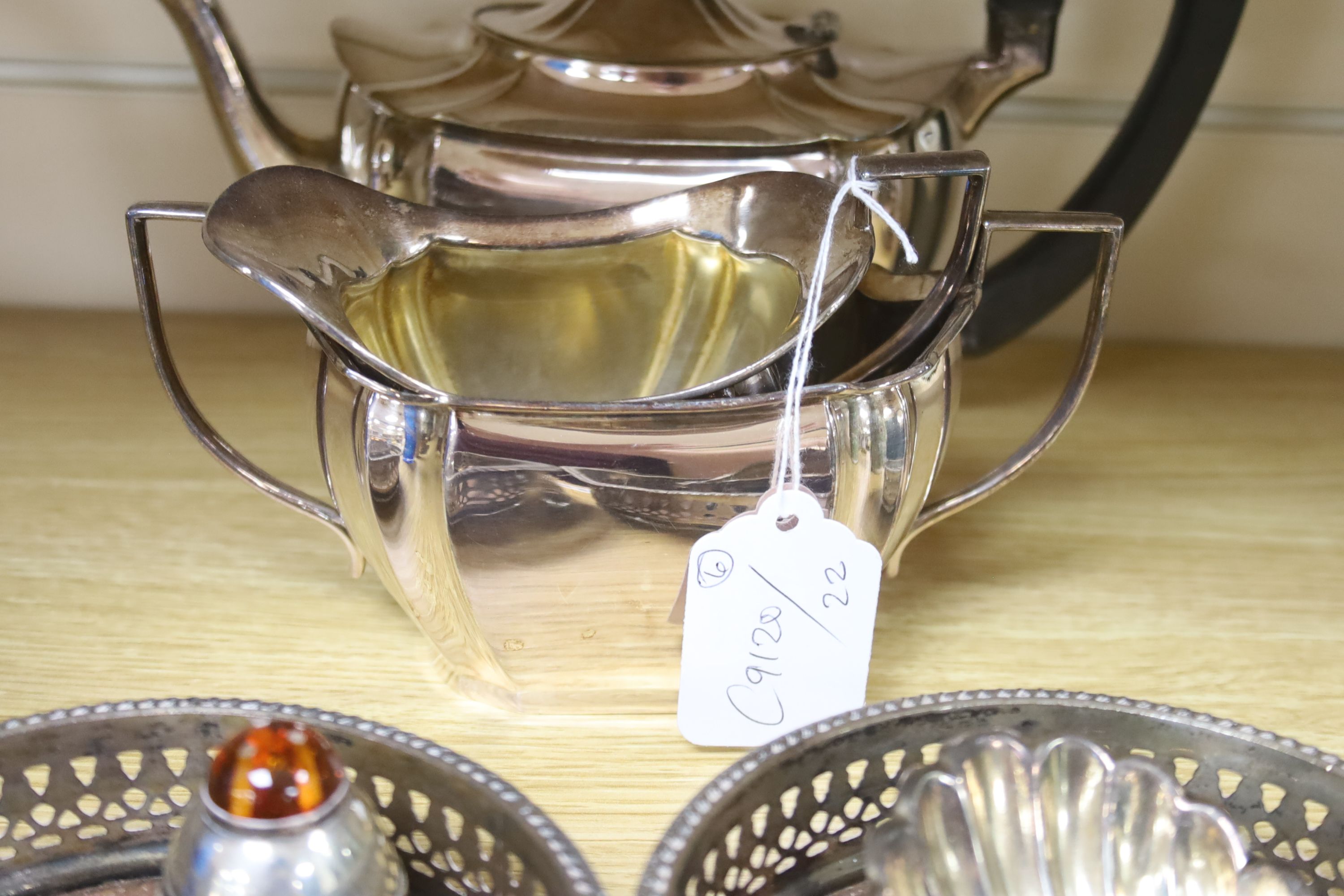 A three piece plated teaset, a pair of coasters and a shell salt